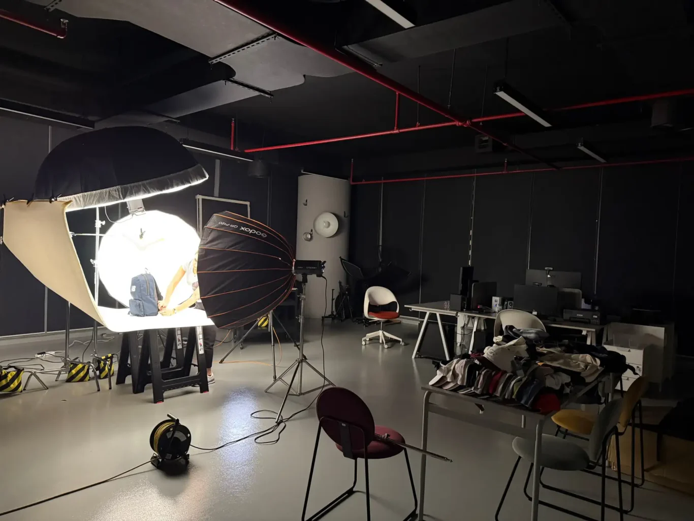 Production set with New Balance caps and bags waiting to be photographed. Behind the scenes of the New Balance e-commerce product photography by MRPS in Dubai.