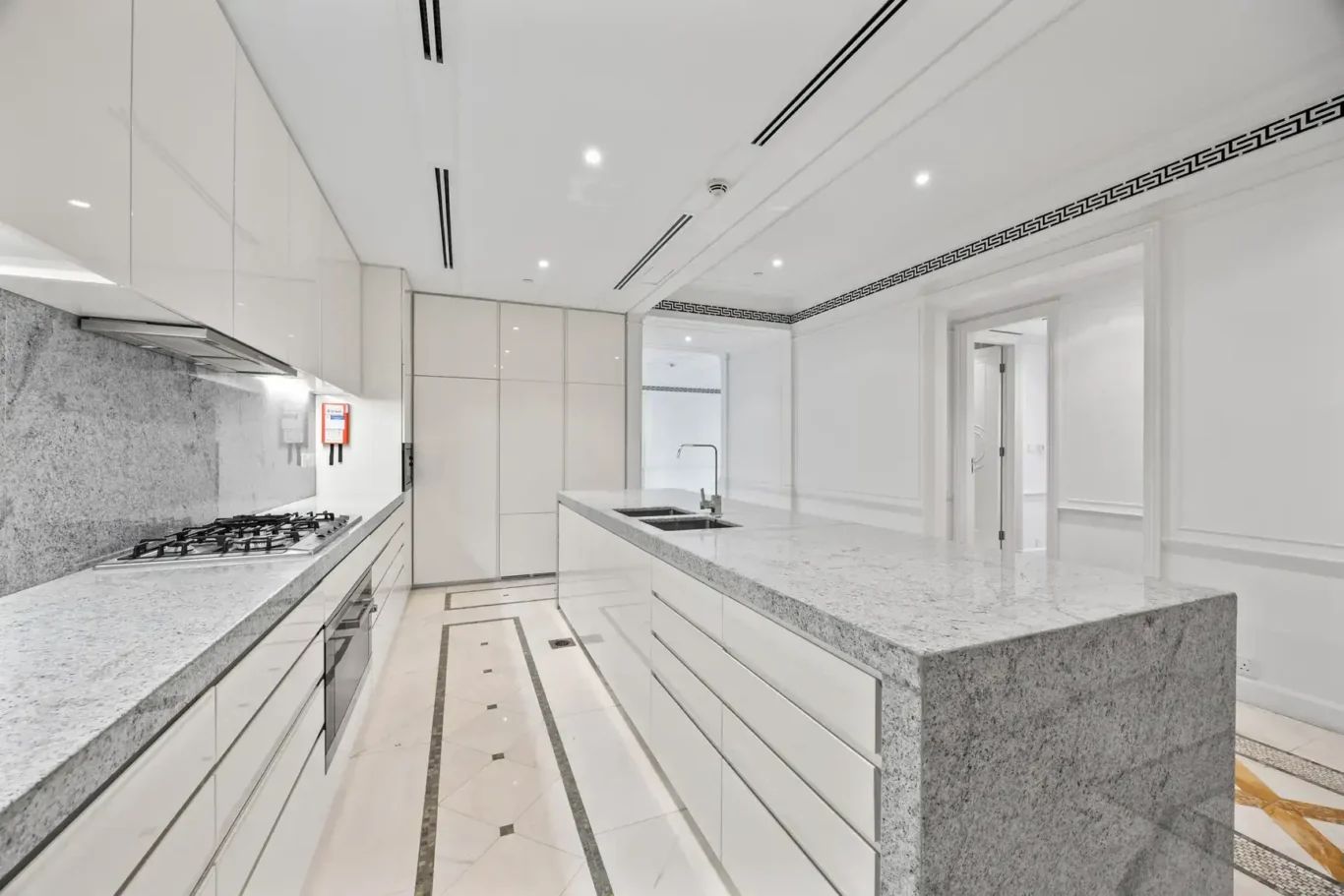 Marble worktops and island in the kitchen in a three-bedroom residence at Palazzo Versace Dubai, Jaddaf Waterfront, photographed for Concierge Auctions.