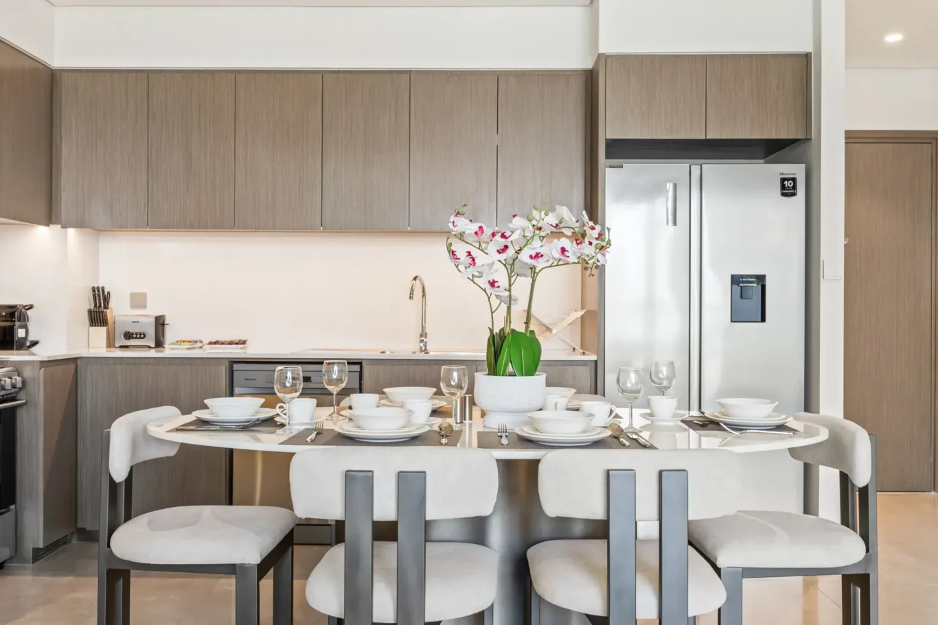 Kitchen and breakfast dining in a two-bedroom StayComfy Holiday Homes apartment at Grande Signature, Downtown Dubai.