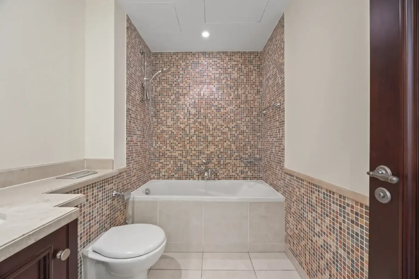 Bathroom with mosaic feature wall in an unfurnished two-bedroom garden apartment in Old Town, Downtown Dubai, photographed for ELITE Property Brokerage.