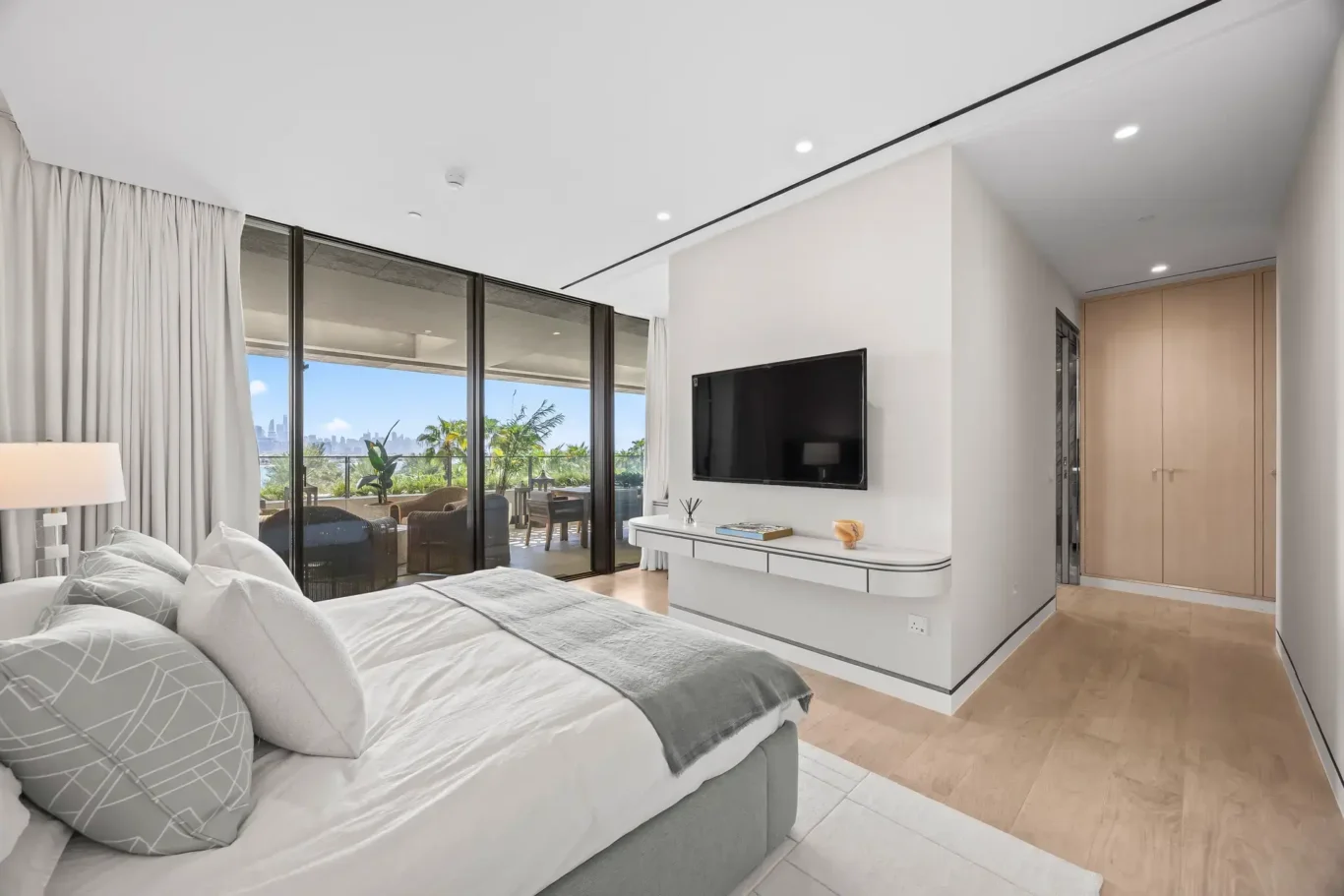Guest bedroom with TV wall and desk in a furnished three-bedroom residence at Atlantis The Royal, Palm Jumeirah, photographed for Apex Homes Real Estate.