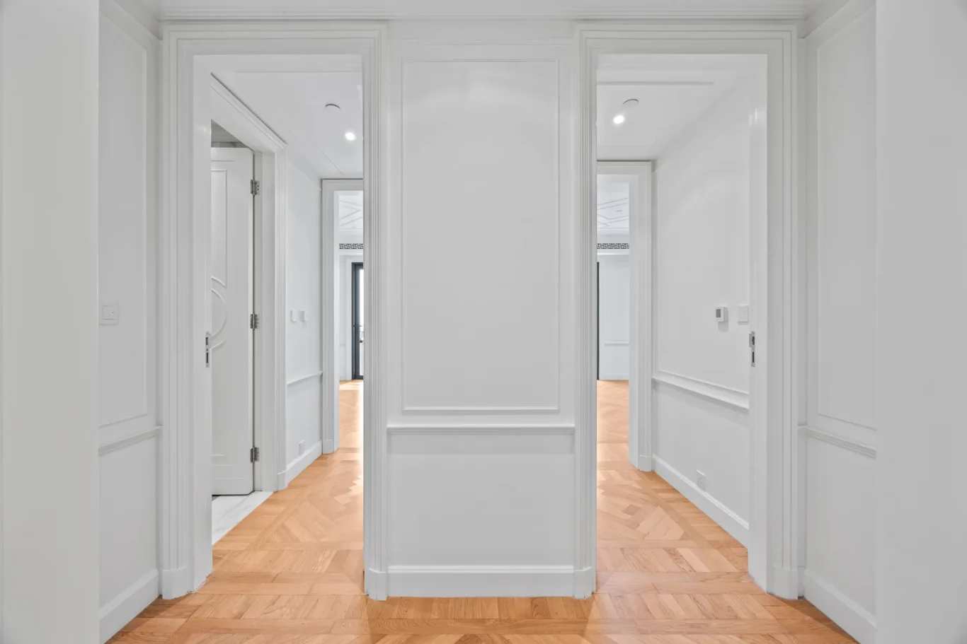 Hallway with panelled doors and parquet floor in a three-bedroom residence at Palazzo Versace Dubai, Jaddaf Waterfront, photographed for Concierge Auctions.
