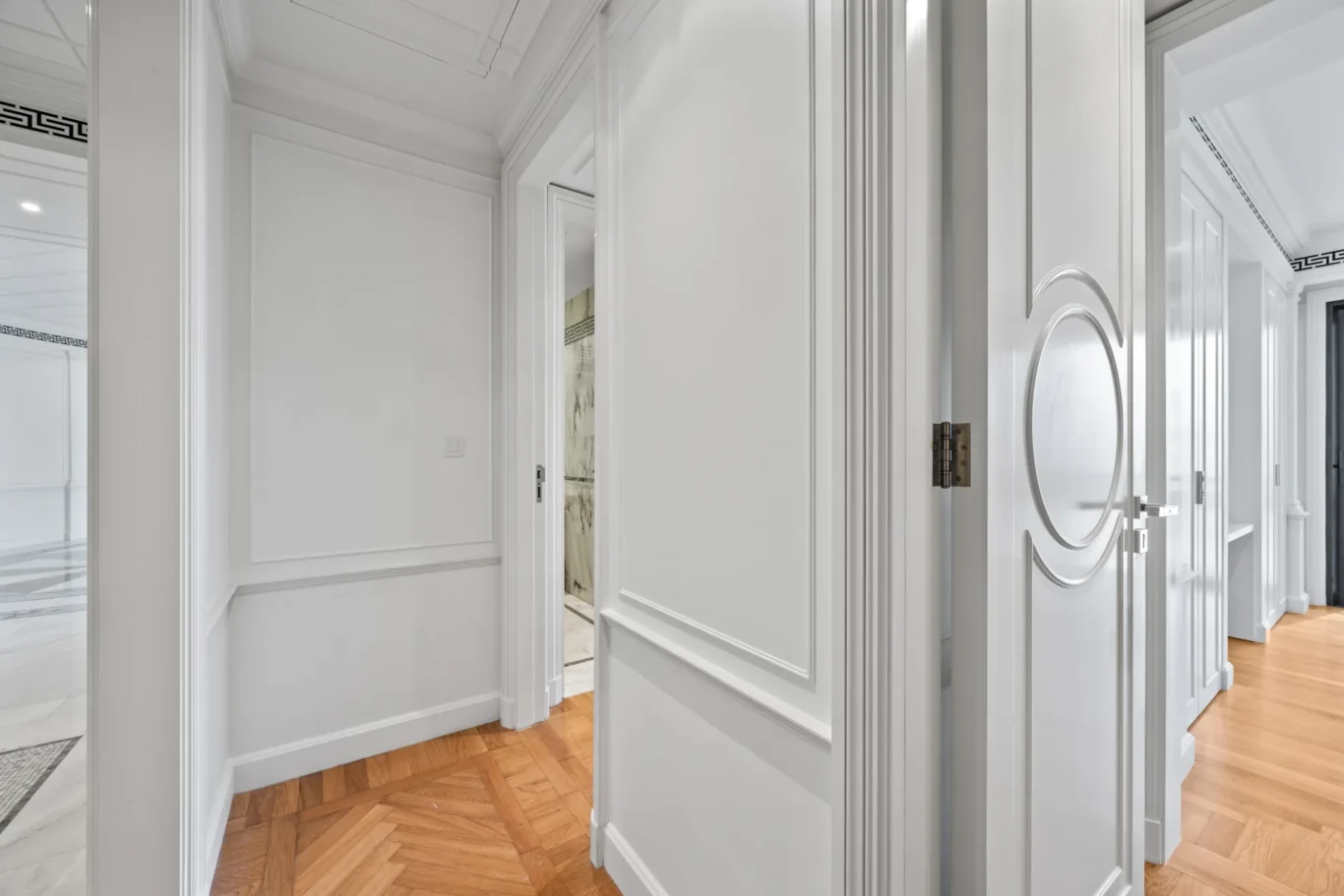 Hallway to the bedrooms with ornate door handles in a three-bedroom residence at Palazzo Versace Dubai, Jaddaf Waterfront, photographed for Concierge Auctions.