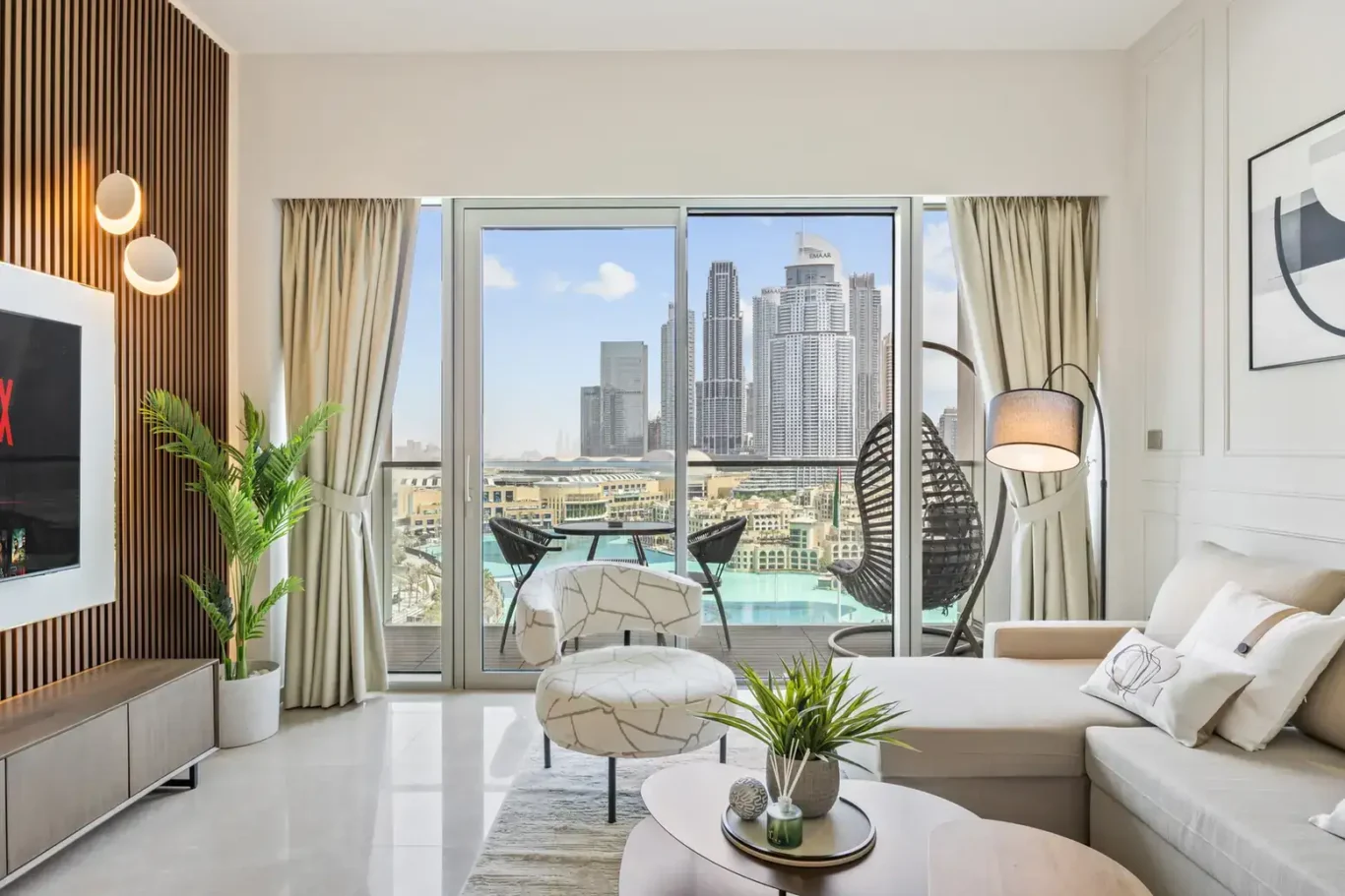 Living room with balcony view in a two-bedroom StayComfy Holiday Homes apartment at Grande Signature, Downtown Dubai.