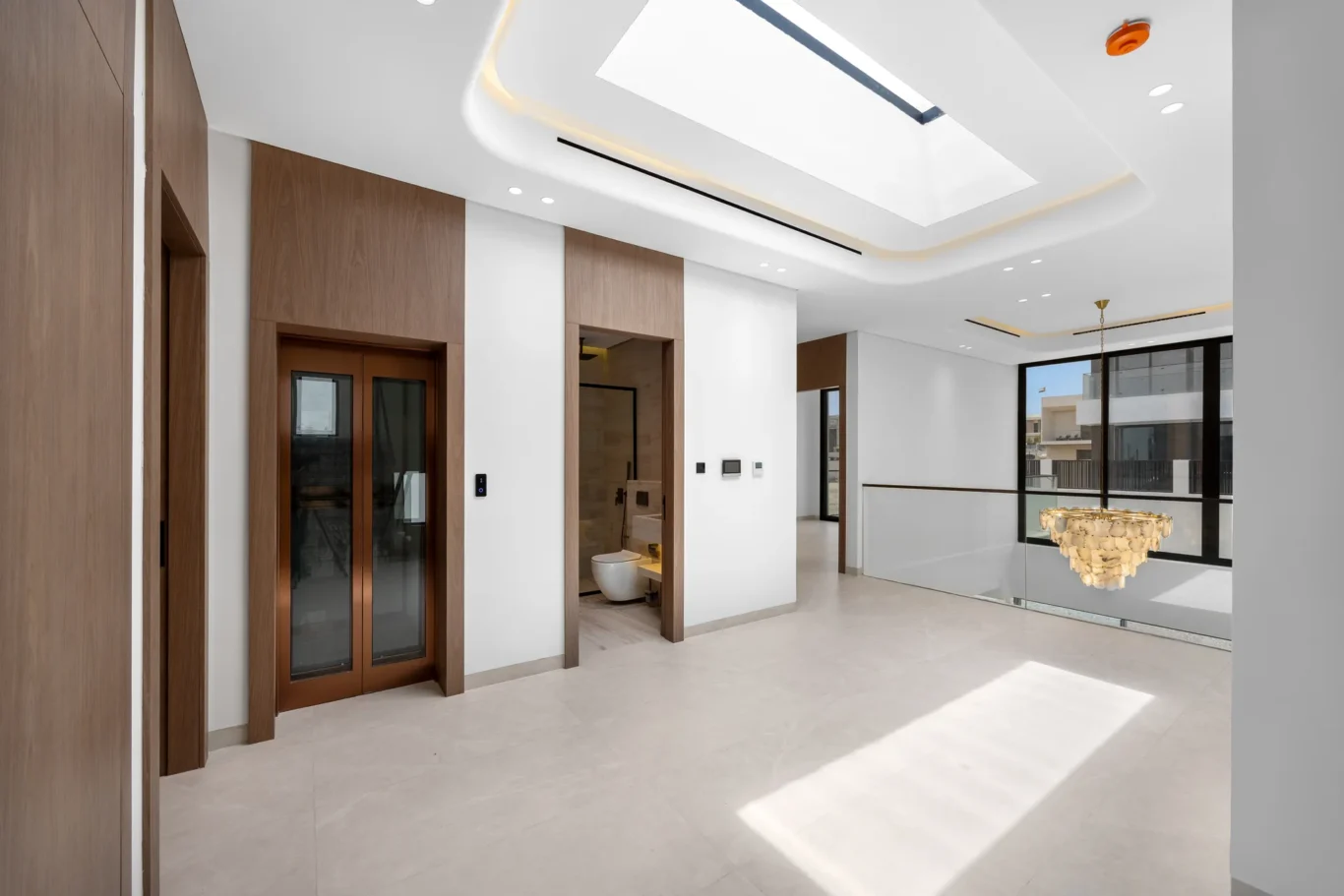 First floor family landing with a skylight above the chandelier void, unfurnished five-bedroom villa in Al Furjan, Dubai.