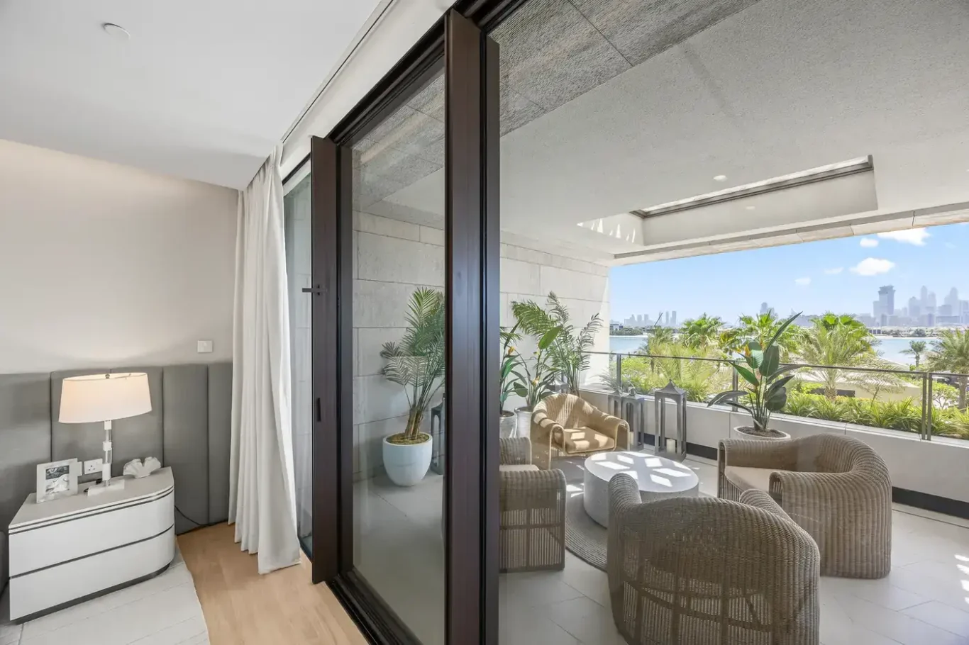 Guest bedroom opening to the terrace in a furnished three-bedroom residence at Atlantis The Royal, Palm Jumeirah, photographed for Apex Homes Real Estate.