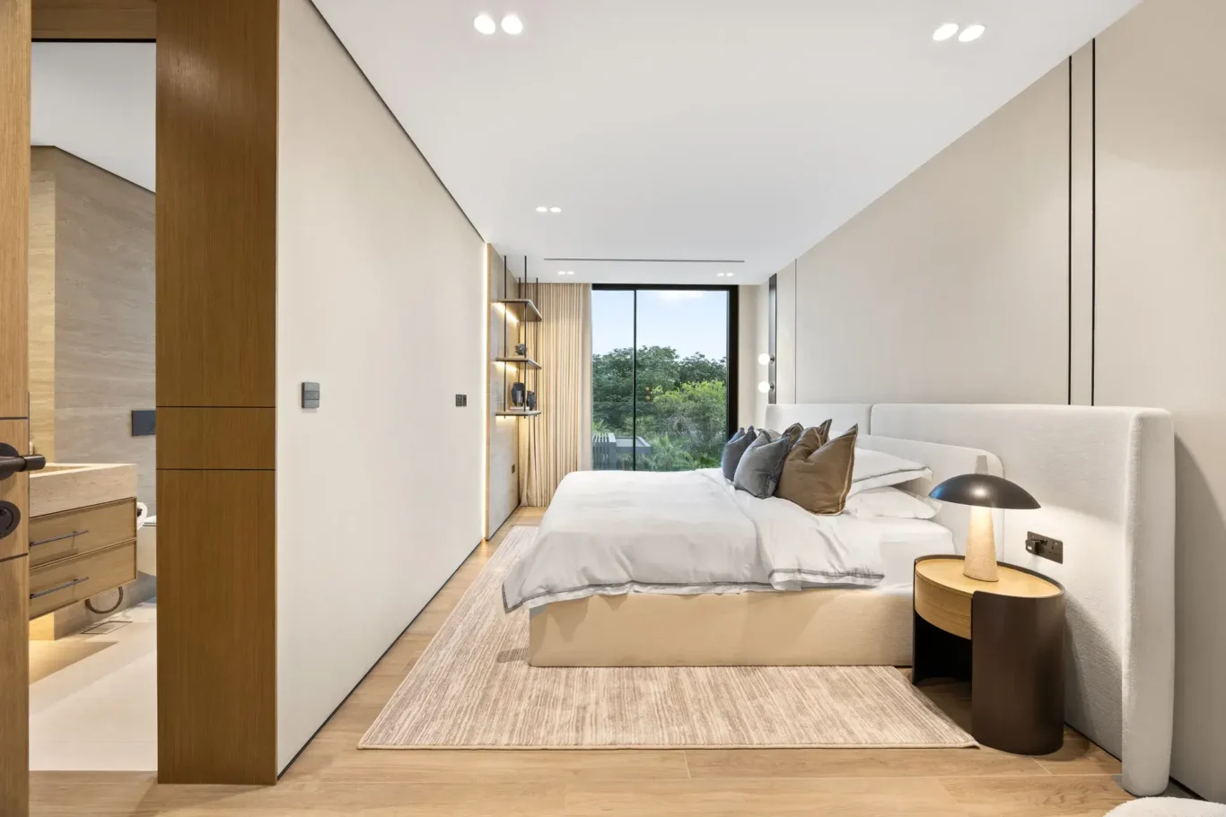 Bedroom with a garden view and soft neutral styling, luxury villa in Jumeirah Islands, Dubai.