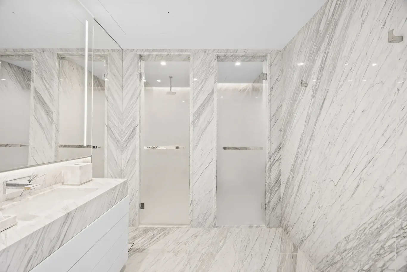 Marble bathroom with glass shower in a furnished three-bedroom residence at Atlantis The Royal, Palm Jumeirah, photographed for Apex Homes Real Estate.