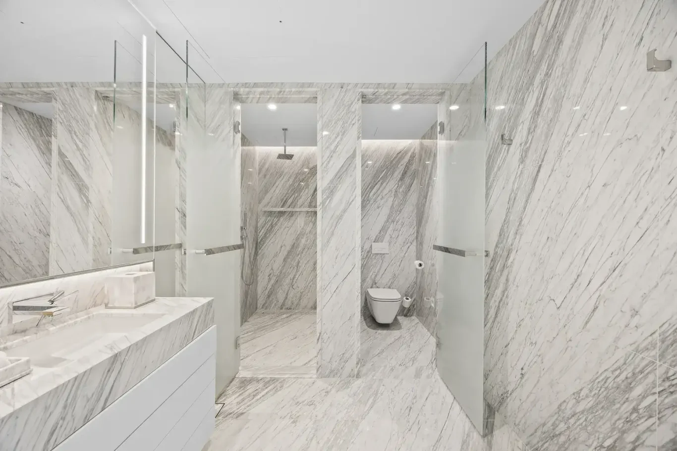 Marble bathroom vanity and shower in a furnished three-bedroom residence at Atlantis The Royal, Palm Jumeirah, photographed for Apex Homes Real Estate.