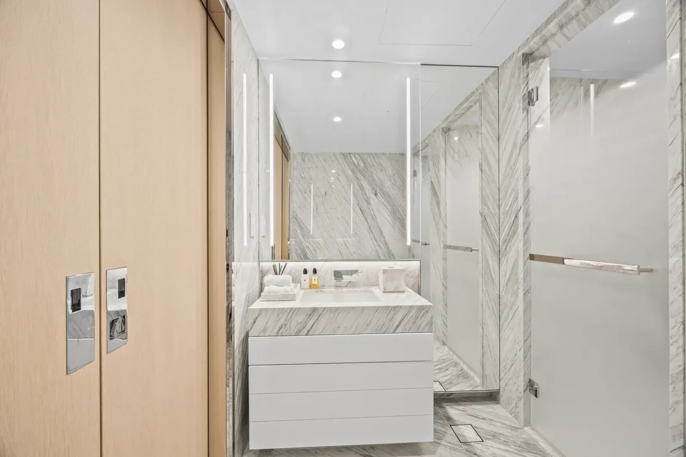 En suite vanity and wardrobes in a furnished three-bedroom residence at Atlantis The Royal, Palm Jumeirah, photographed for Apex Homes Real Estate.