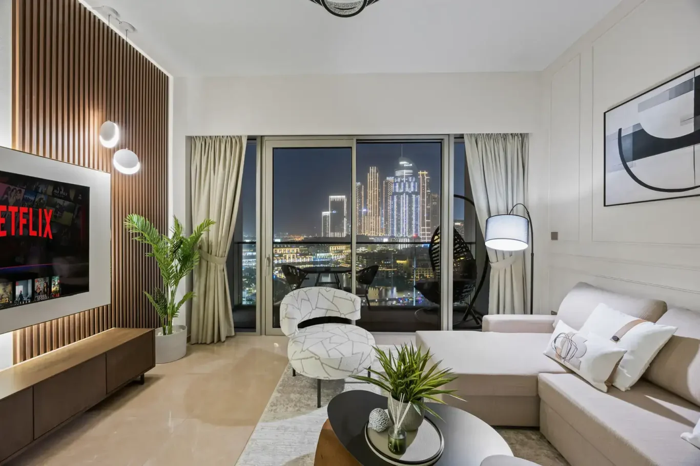Lounge with balcony doors open in a two-bedroom StayComfy Holiday Homes apartment at Grande Signature, Downtown Dubai.