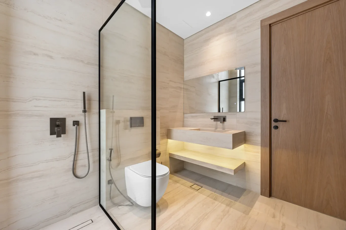 En-suite bathroom with a glass shower and floating vanity, unfurnished five-bedroom villa in Al Furjan, Dubai.