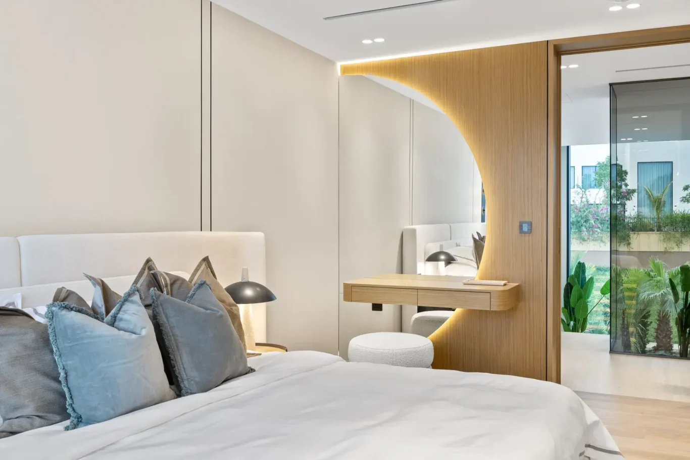 Bedroom with a dressing nook and a door to the balcony, luxury villa in Jumeirah Islands, Dubai.