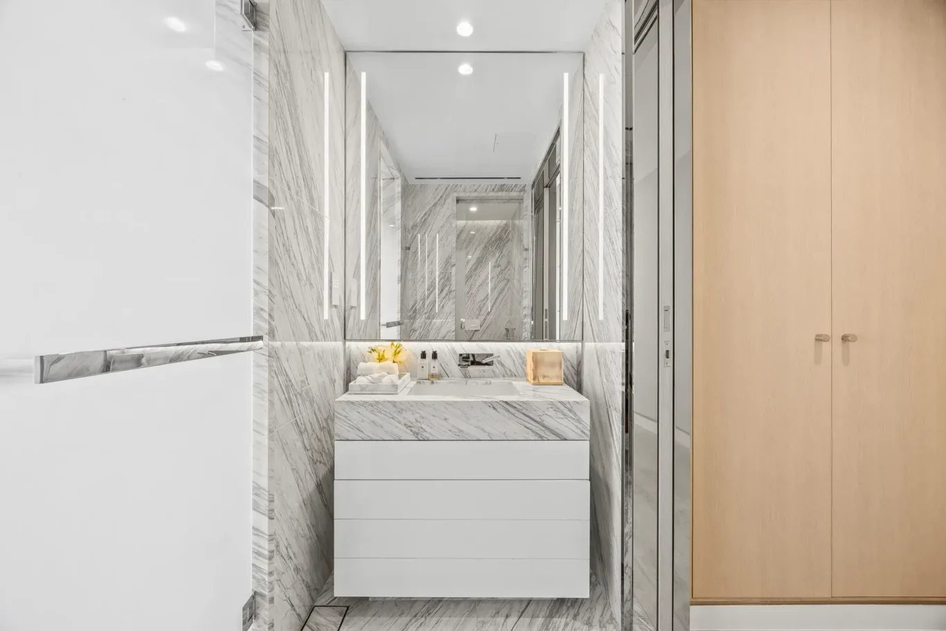 Bathroom vanity with backlit mirror in a furnished three-bedroom residence at Atlantis The Royal, Palm Jumeirah, photographed for Apex Homes Real Estate.