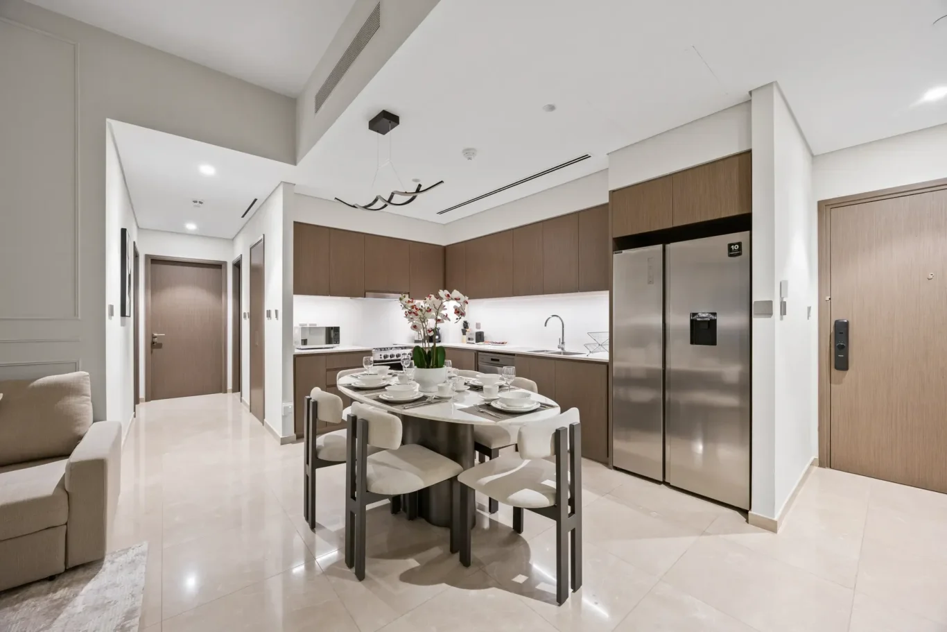 Hallway view of kitchen and dining in a two-bedroom StayComfy Holiday Homes apartment at Grande Signature, Downtown Dubai.