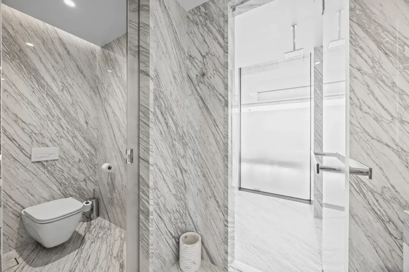 Marble bathroom with WC and shower in a furnished three-bedroom residence at Atlantis The Royal, Palm Jumeirah, photographed for Apex Homes Real Estate.
