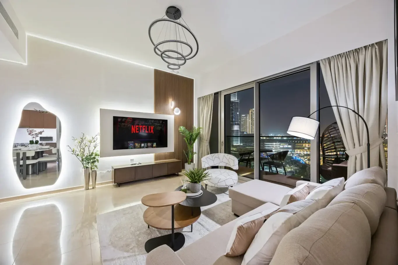 Living room at night with TV in a two-bedroom StayComfy Holiday Homes apartment at Grande Signature, Downtown Dubai.