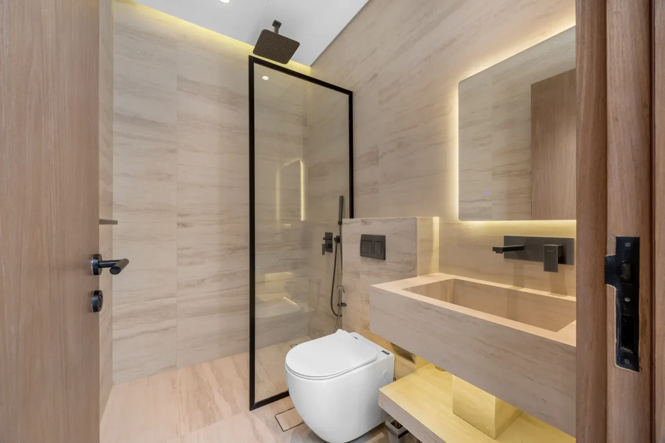 En-suite bathroom with a backlit mirror and stone basin, unfurnished five-bedroom villa in Al Furjan, Dubai.