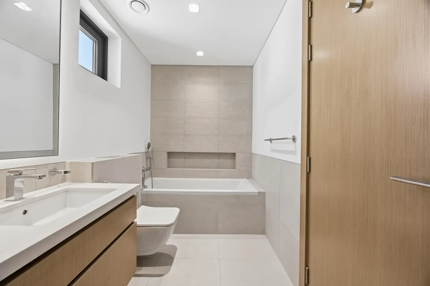 Bathroom with bathtub and timber vanity. Villa photography by MRPS in Dubai for ELITE Property Brokerage.