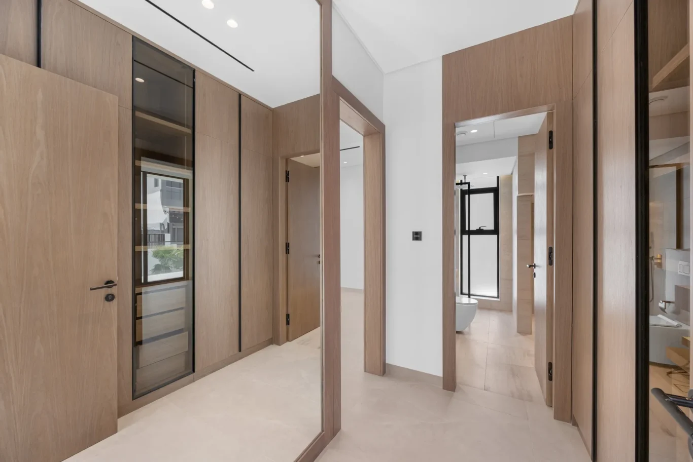Walk-in wardrobe corridor leading to the bedroom, unfurnished five-bedroom villa in Al Furjan, Dubai.