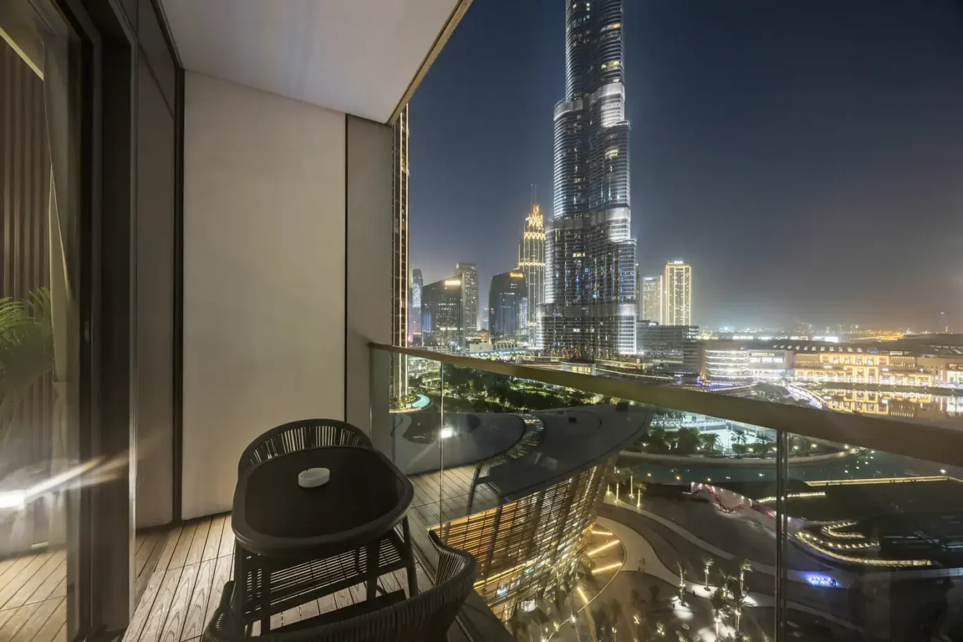 Balcony with Burj Khalifa illuminated in a two-bedroom StayComfy Holiday Homes apartment at Grande Signature, Downtown Dubai.