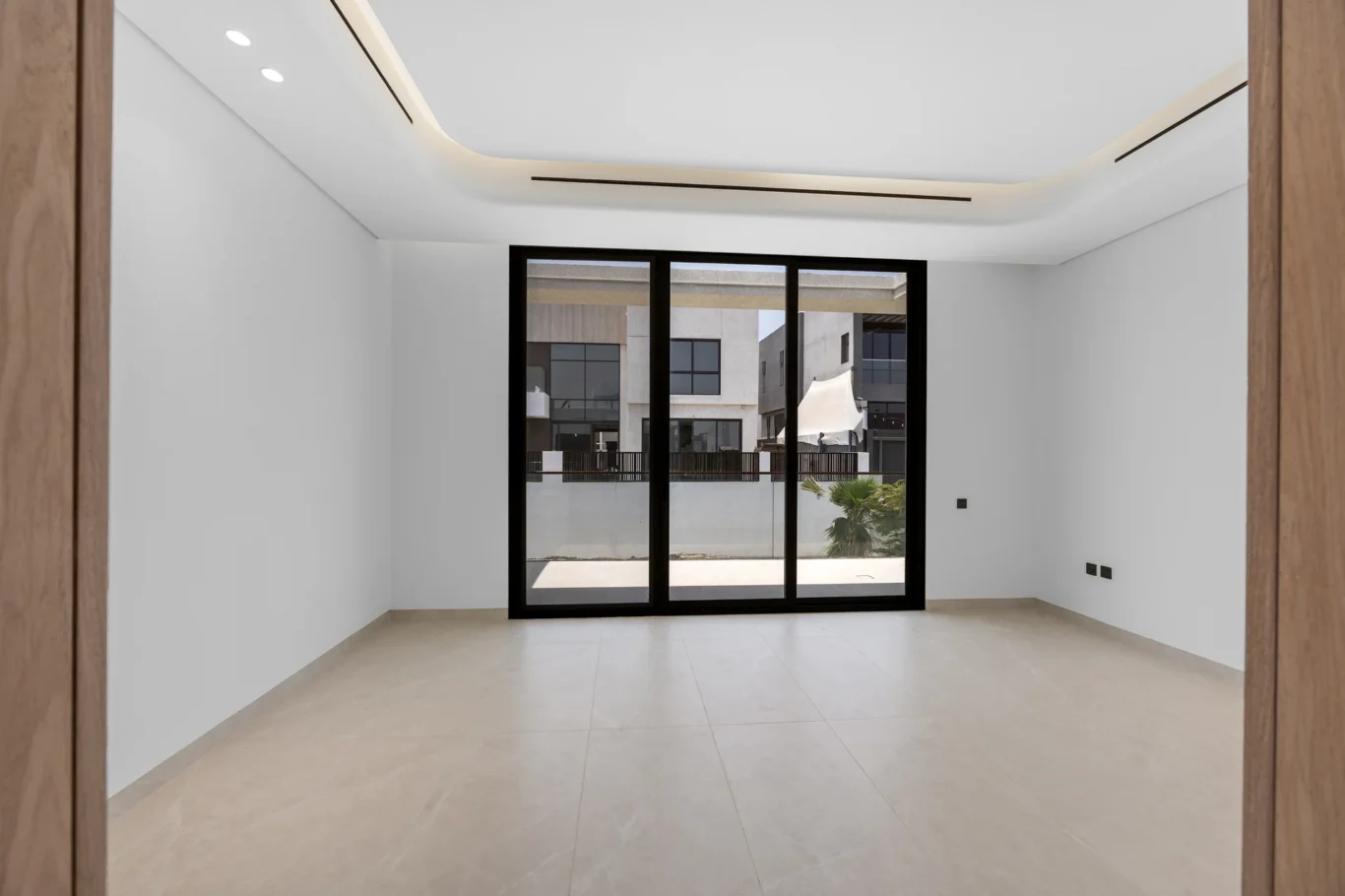 Bedroom with sliding doors to the balcony, unfurnished five-bedroom villa in Al Furjan, Dubai.