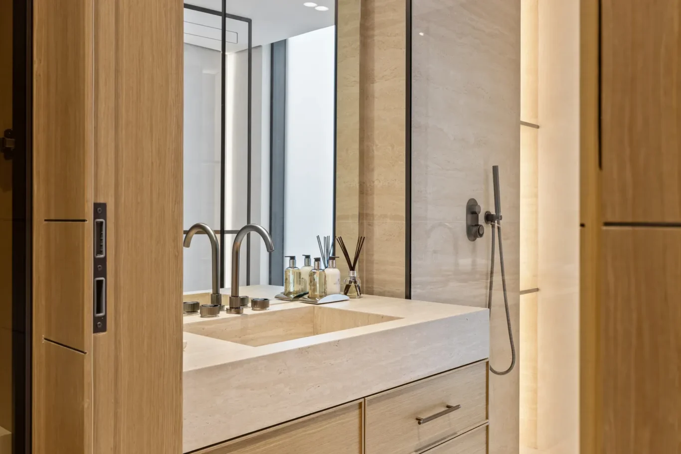 Bathroom vanity with a stone basin and brushed taps, luxury villa in Jumeirah Islands, Dubai.