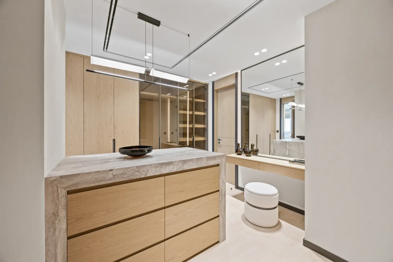 Dressing room island and vanity with a pendant light, luxury villa in Jumeirah Islands, Dubai.