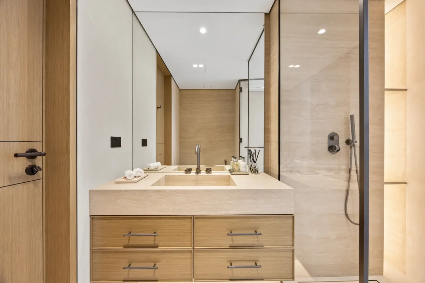 Bathroom vanity with wood drawers and a tall mirror, luxury villa in Jumeirah Islands, Dubai.