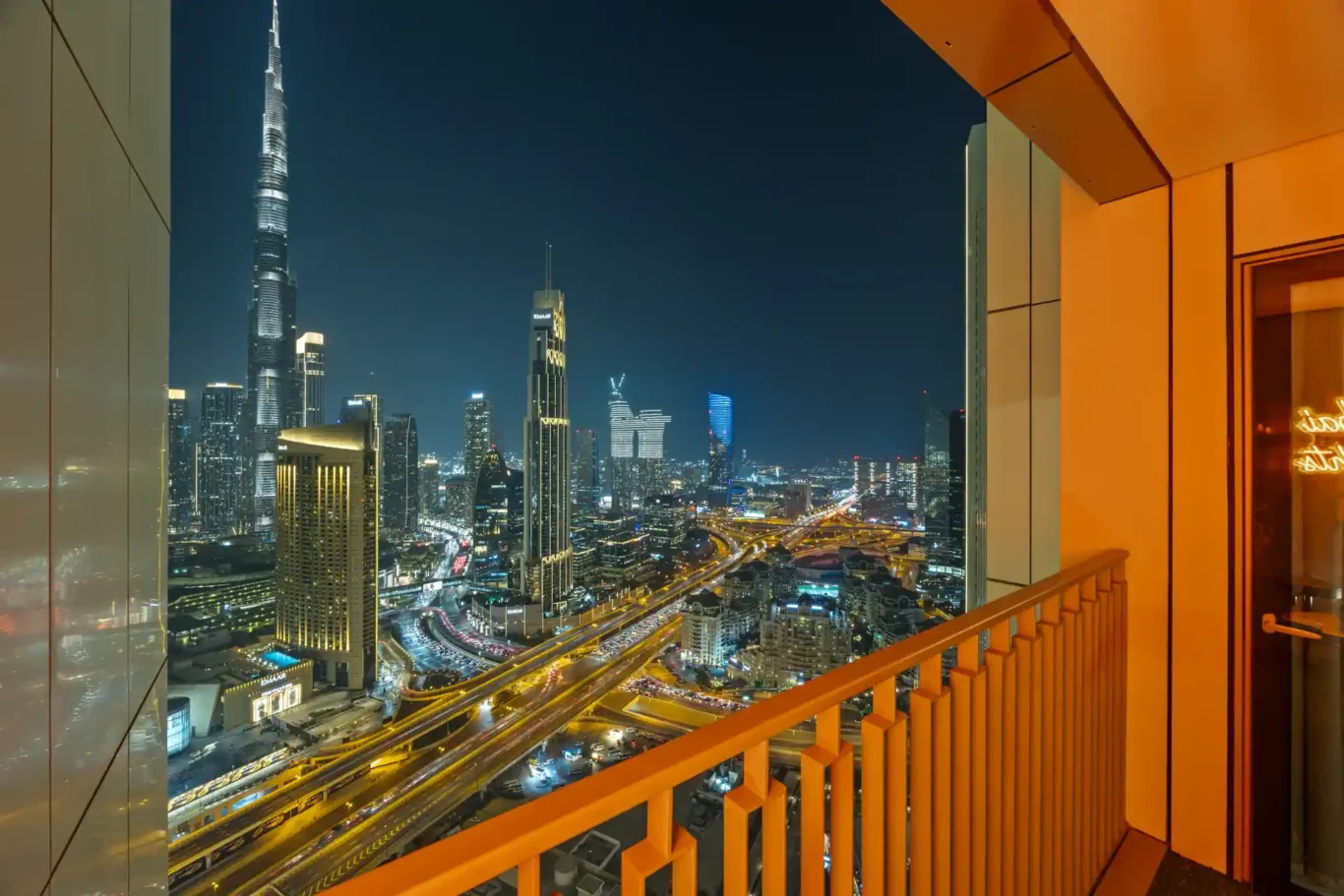 Night view over Downtown Dubai with the lit roads and towers. Day, twilight and night Airbnb photography by MRPS for Vista Haus Holiday Homes in Downtown Dubai.