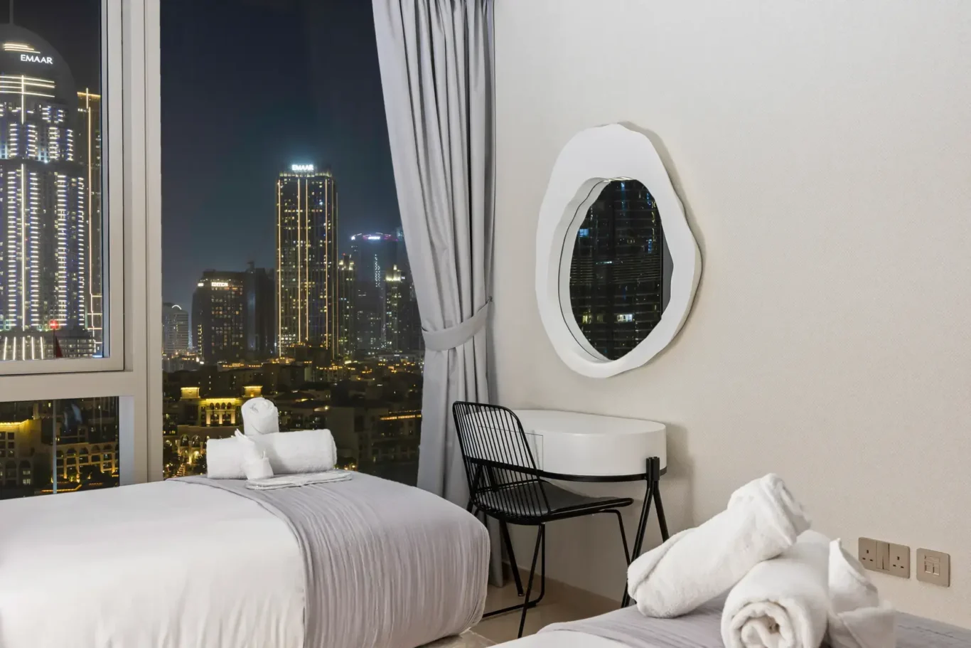 Bedroom night skyline view in a two-bedroom StayComfy Holiday Homes apartment at Grande Signature, Downtown Dubai.