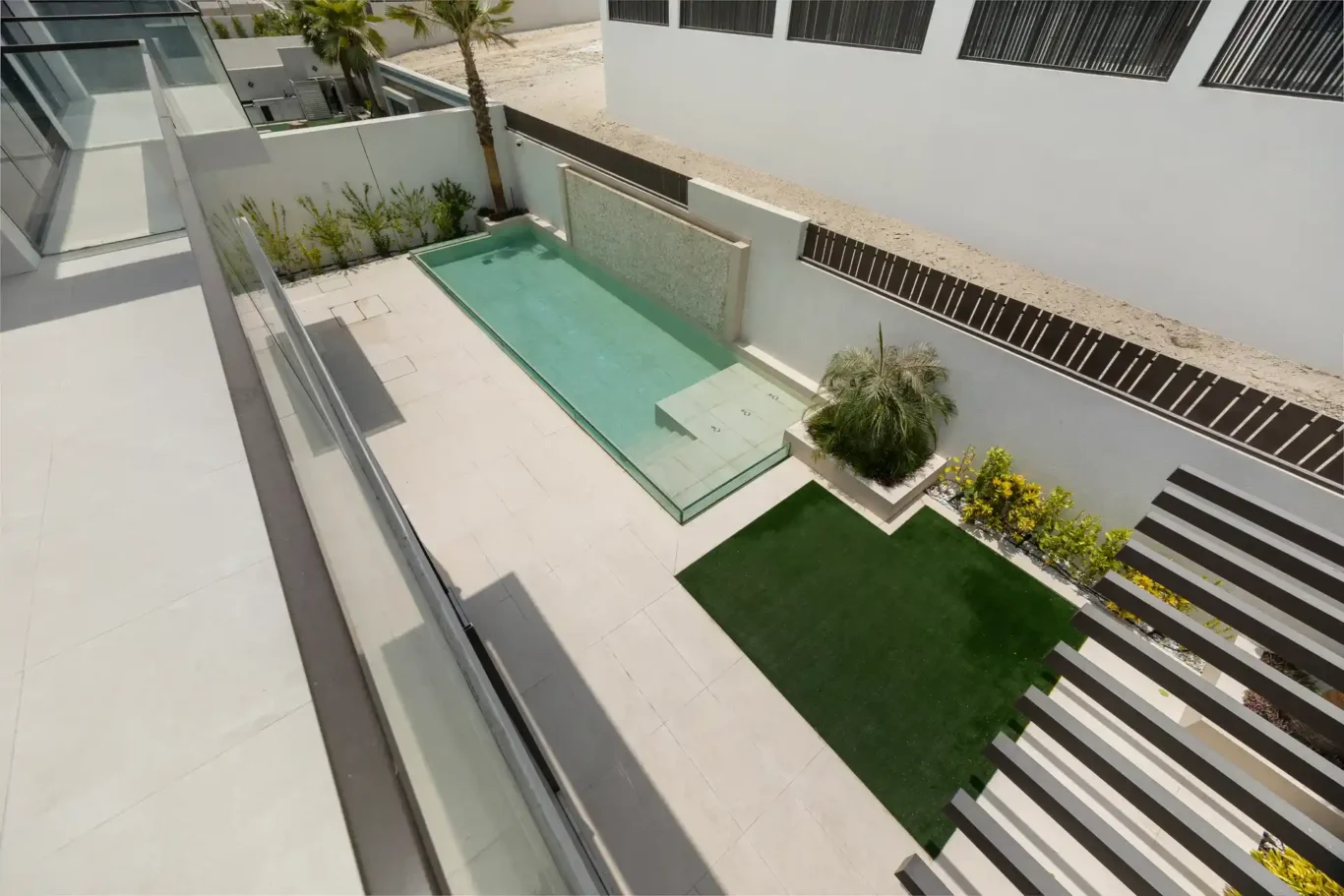 View from the terrace down to the pool and garden, unfurnished five-bedroom villa in Al Furjan, Dubai.
