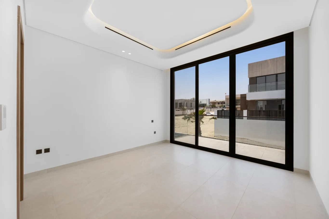 Bedroom with sliding doors to the terrace, unfurnished five-bedroom villa in Al Furjan, Dubai.