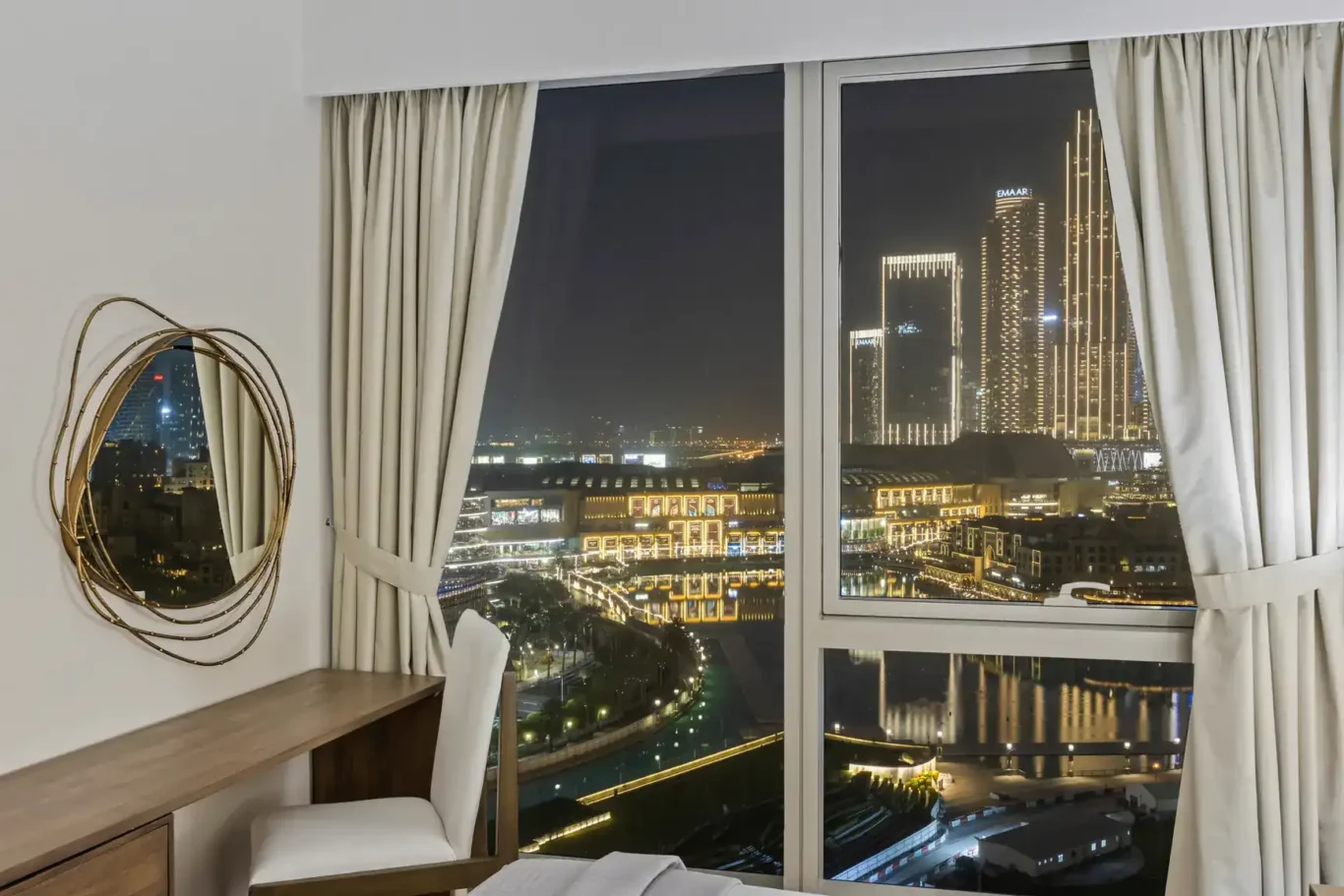Bedroom desk with night view in a two-bedroom StayComfy Holiday Homes apartment at Grande Signature, Downtown Dubai.