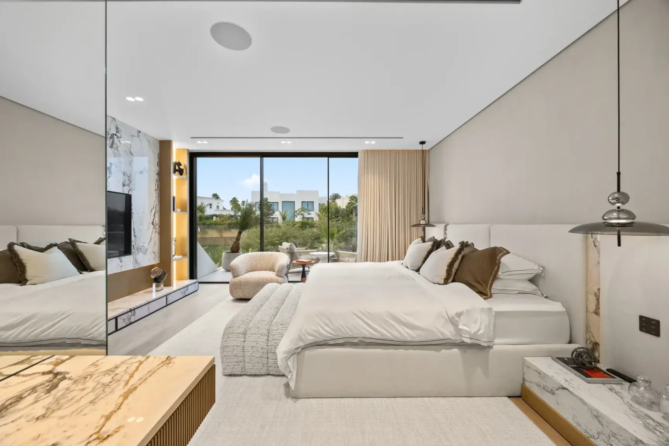 Wide view of the master bedroom with pendant lights, luxury villa in Jumeirah Islands, Dubai.