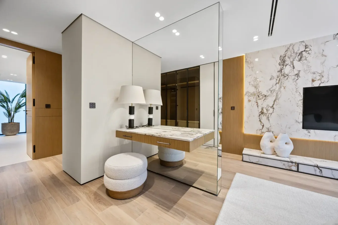 Master bedroom dressing table beside the marble TV wall, luxury villa in Jumeirah Islands, Dubai.