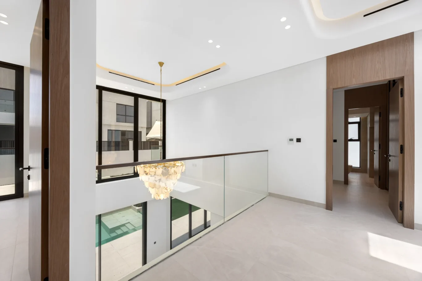 First floor gallery with a glass balustrade over the living room, unfurnished five-bedroom villa in Al Furjan, Dubai.