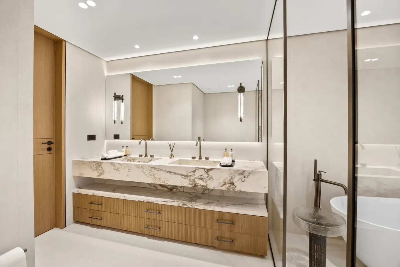 Master bathroom marble double vanity with a wide mirror, luxury villa in Jumeirah Islands, Dubai.