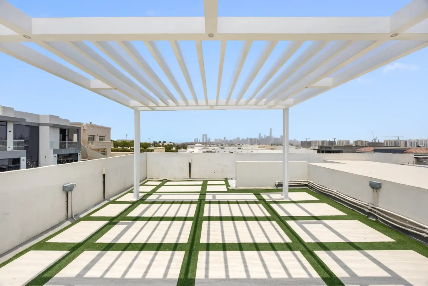 Roof terrace with a white pergola, unfurnished five-bedroom villa in Al Furjan, Dubai.
