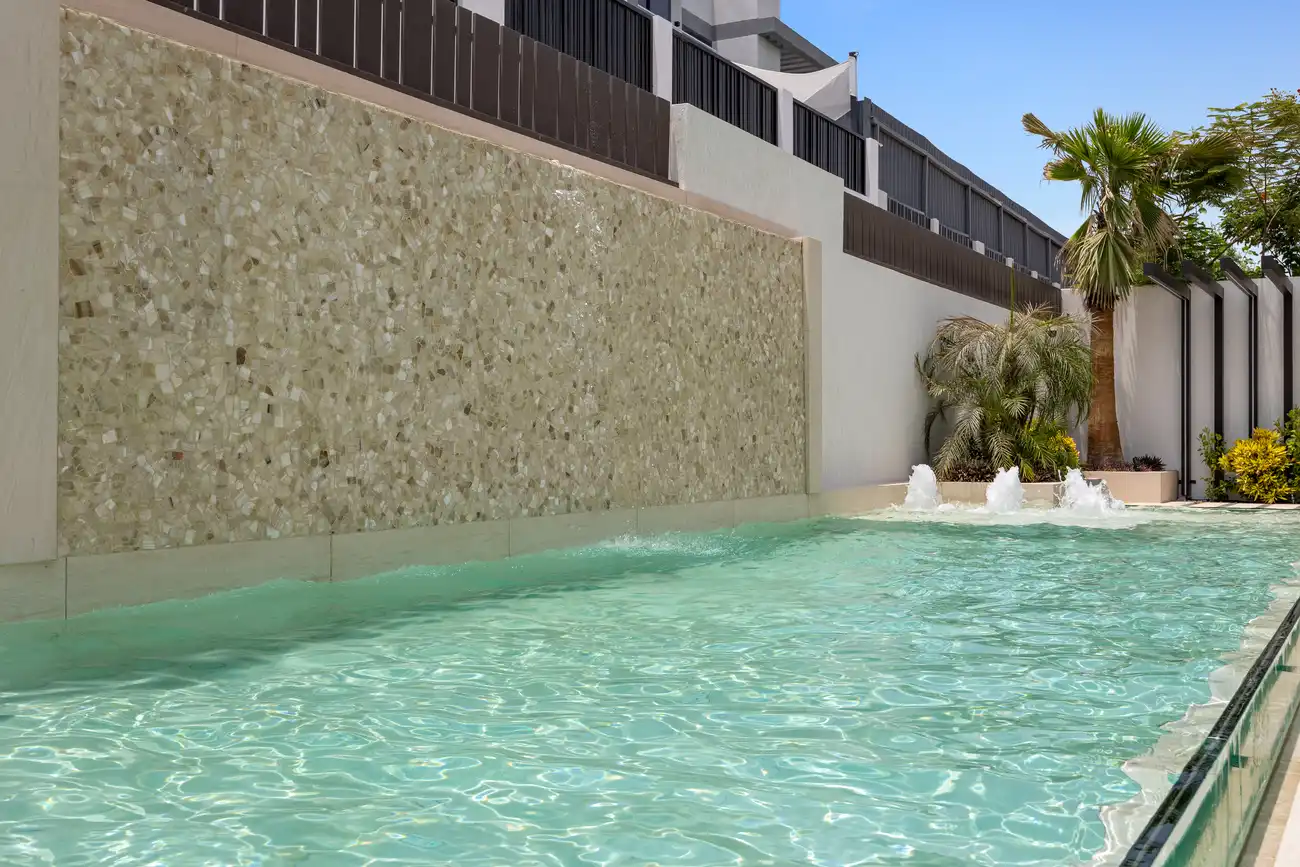 Swimming pool with fountains and a mosaic feature wall, unfurnished five-bedroom villa in Al Furjan, Dubai.