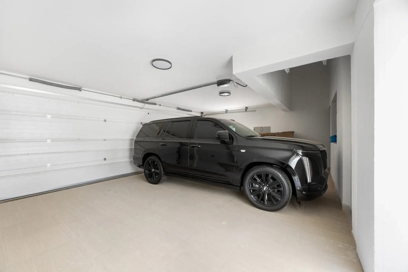 Garage with a parked black SUV, unfurnished five-bedroom villa in Al Furjan, Dubai.