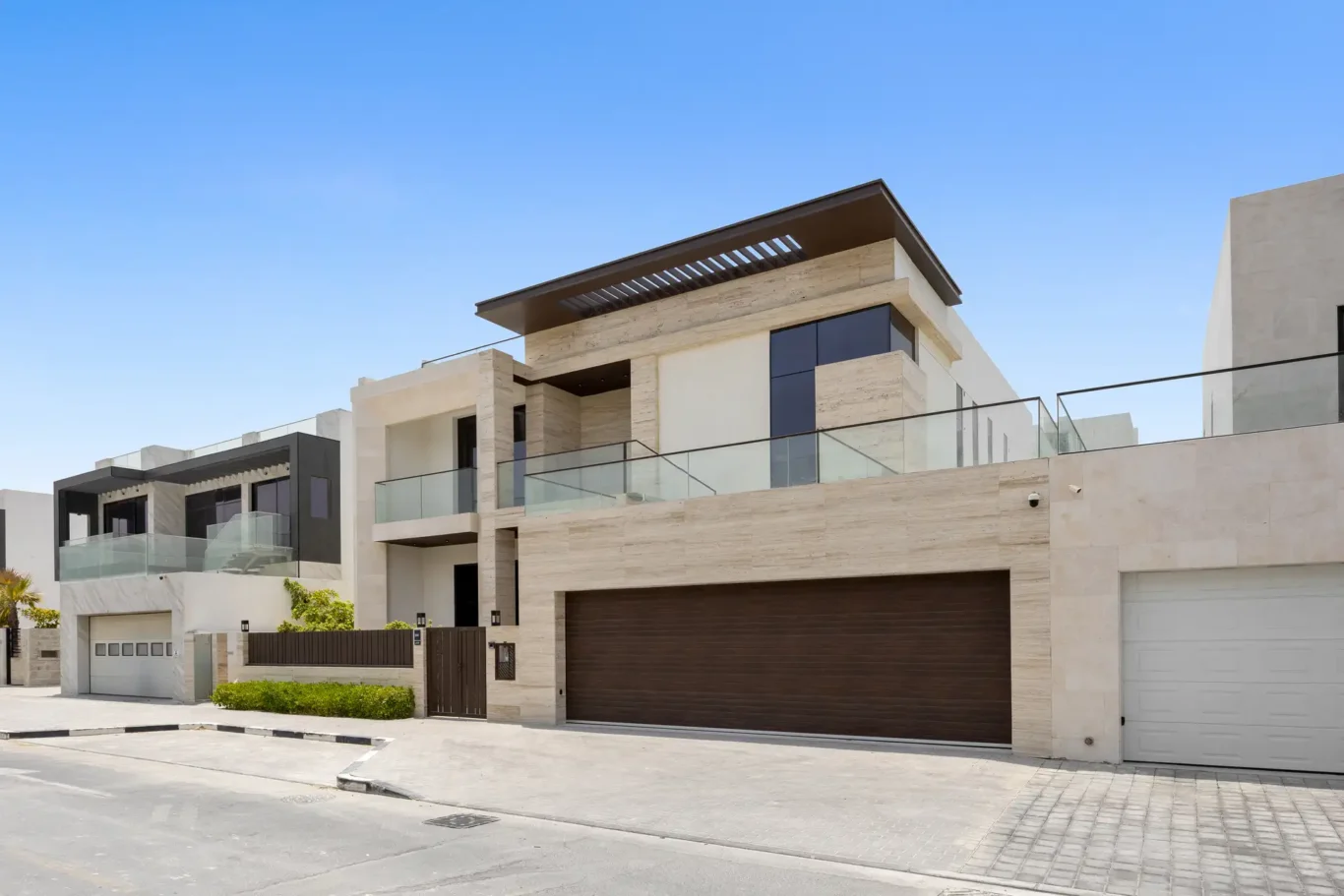 Angled view of the front exterior and garage, unfurnished five-bedroom villa in Al Furjan, Dubai.