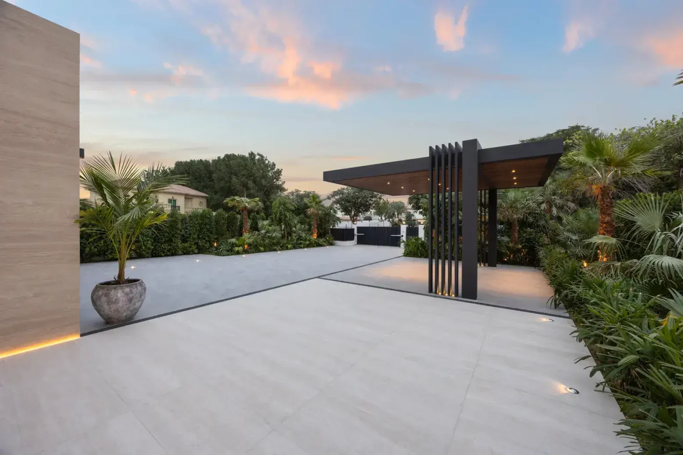 Driveway and carport under a sunset sky, luxury villa in Jumeirah Islands, Dubai.
